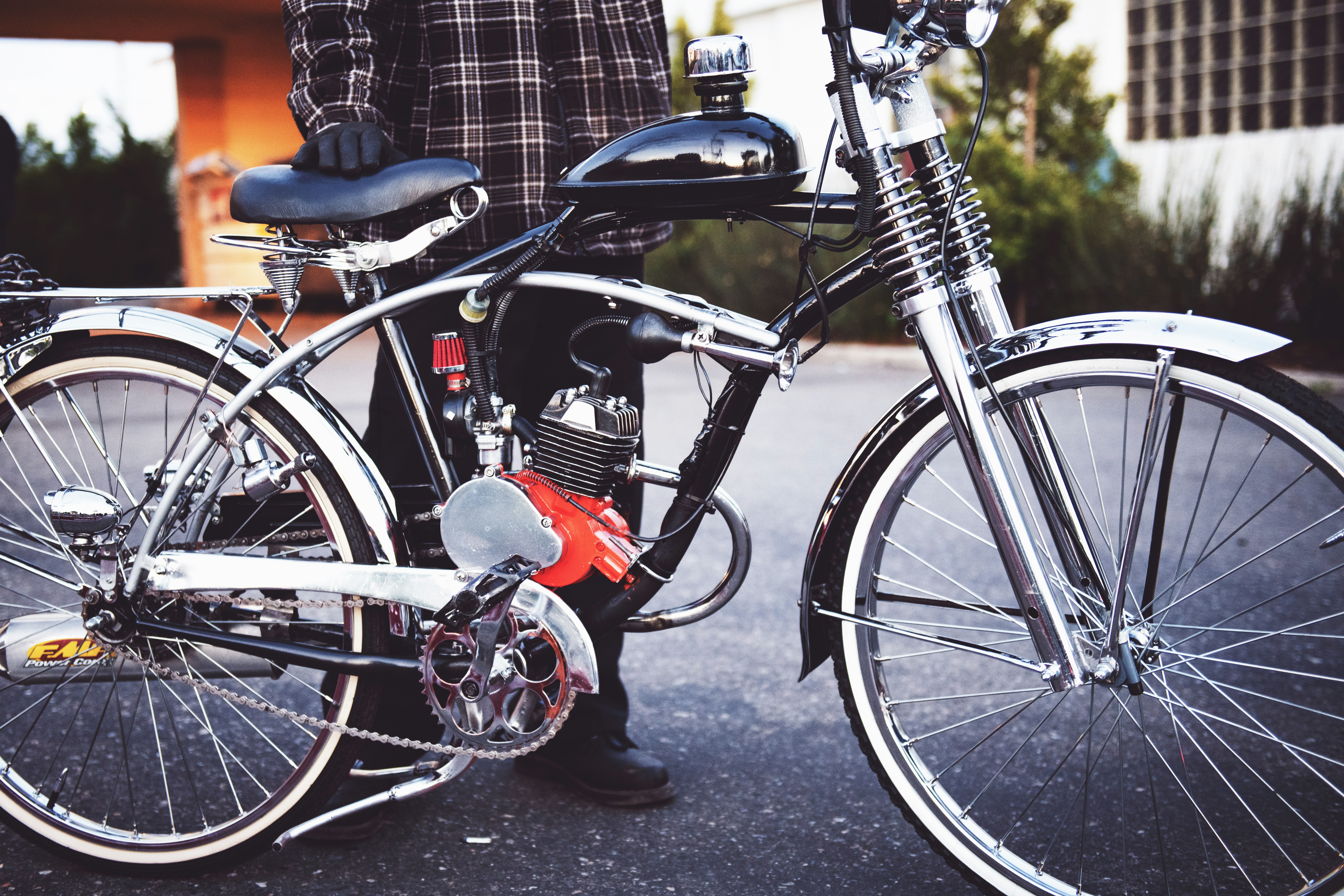 person holding black motorized bicycle